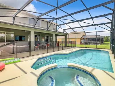 a swimming pool with a glass roof over a house at 7BR Villa in Emerald Island w/ Resort Perks in Kissimmee