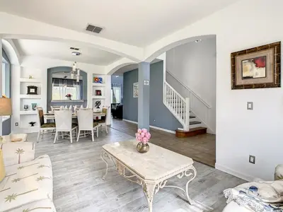 a living room with a table and a dining room at 7BR Villa in Emerald Island w/ Resort Perks in Kissimmee