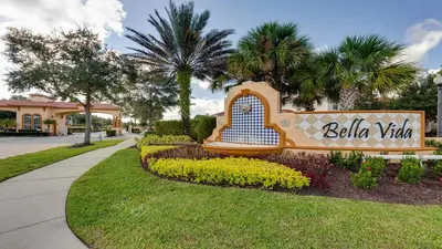 a sign for the bellida village in a park at 3-Bedroom Villa in Bella Vida Resort, Close2Disney in Kissimmee