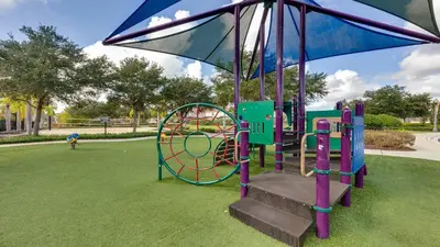 a playground in a park with a slide at 3-Bedroom Villa in Bella Vida Resort, Close2Disney in Kissimmee