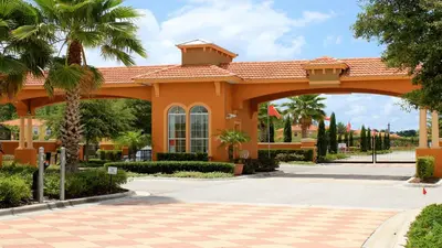 a large orange building with an arch in a courtyard at 3-Bedroom Villa in Bella Vida Resort, Close2Disney in Kissimmee