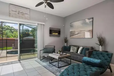 a living room with a couch and a tv at 3-Bedroom Villa in Bella Vida Resort, Close2Disney in Kissimmee