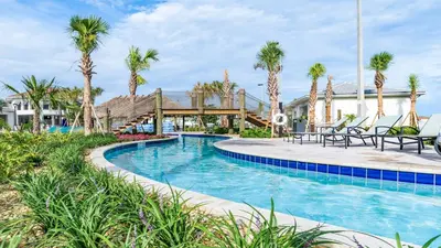 a pool at a resort with palm trees at Epic Family Getaway: Themed Villa Near Disney ! in Kissimmee