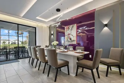 a dining room with a white table and chairs at Epic Family Getaway: Themed Villa Near Disney ! in Kissimmee