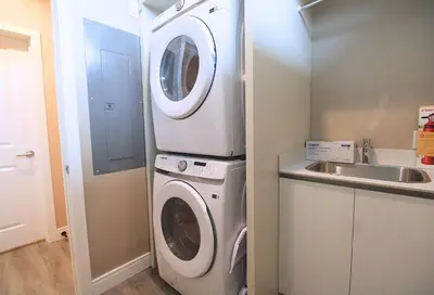 a laundry room with a washer and dryer next to a sink at NEW Luxury Oasis at Magic Village in Kissimmee