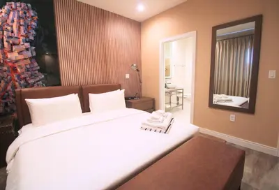 a bedroom with a large white bed and a mirror at NEW Luxury Oasis at Magic Village in Kissimmee