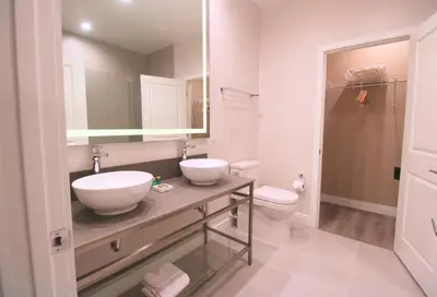 a bathroom with two sinks and a toilet at NEW Luxury Oasis at Magic Village in Kissimmee