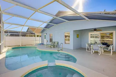 a large swimming pool with a glass ceiling at 9 Mi to Walt Disney World Family Home with Pool! in Orlando