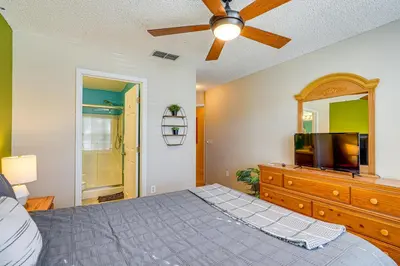 a bedroom with a bed and a flat screen tv at 9 Mi to Walt Disney World Family Home with Pool! in Orlando