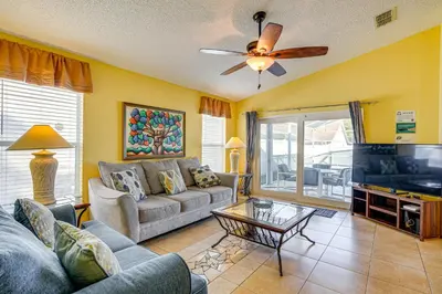 a living room with a couch and a table at 9 Mi to Walt Disney World Family Home with Pool! in Orlando