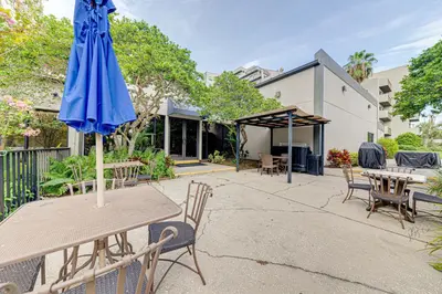 a patio with a table with an umbrella at Cozy Lakeview Getaway Near Universal Studios 2602 in Orlando