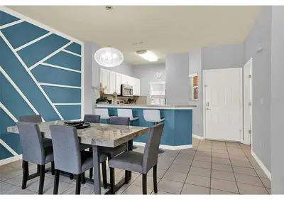 a kitchen and dining room with a table and chairs at 3157 YL - Encantada Serenity Retreat Elegant Villa Close to Disney in Kissimmee