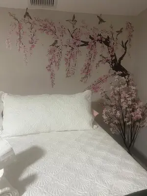 a bedroom with a bed with a tree mural on the wall at The Secret Garden Games Getaway in Orlando