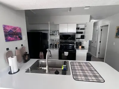 a kitchen with a sink and a counter top at 3-BR Condo near Disney & Universal in Kissimmee