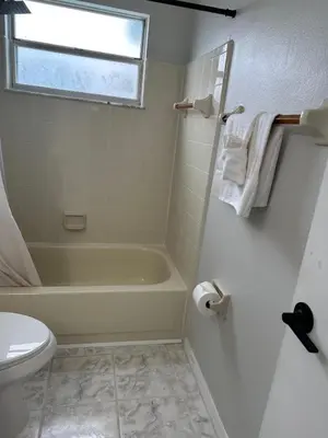 a bathroom with a tub and a toilet and a sink at 3-BR Condo near Disney & Universal in Kissimmee