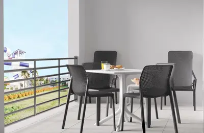 a group of chairs around a table on a balcony at Villatel Orlando Resort, Apartments by Marriott Bonvoy in Orlando