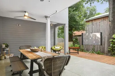 a patio with a wooden table and chairs and a screen at Great Outdoor Area in Orlando