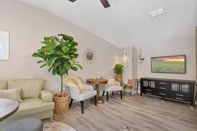 a living room with a couch and a table at Great Outdoor Area in Orlando