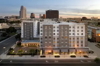 a large white building with a city in the background at Residence Inn by Marriott Orlando Downtown in Orlando