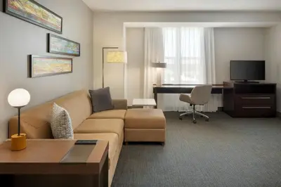 a living room with a couch and a desk at Residence Inn by Marriott Orlando Downtown in Orlando