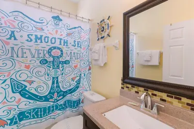 a bathroom with a shower curtain with an anchor on it at Aruba Palms Villa Near Disney & Attractions in Kissimmee