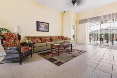 a living room with a couch and a coffee table at Aruba Palms Villa Near Disney & Attractions in Kissimmee