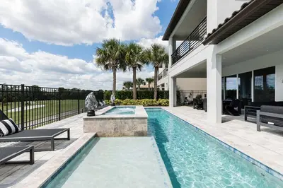 a swimming pool in the backyard of a house at The Nicklaus View Haven-TB007 in Orlando