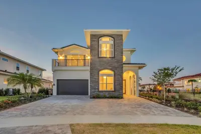 a large house with a driveway in front of it at The Luxurious Bear's Den Estate-TB009 in Orlando