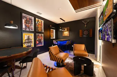 a bar with orange chairs and a table at 2858 Storey Lake brand new 19guests pool game room in Kissimmee