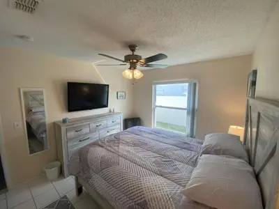 a bedroom with a bed and a flat screen tv at Beautiful Indian Ridge Home - Close to Disney in Orlando