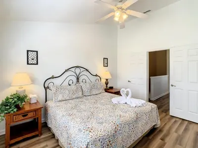 a bedroom with a bed and a ceiling fan at Celtic Palms: Private Pool & Near Disney Magic in Kissimmee