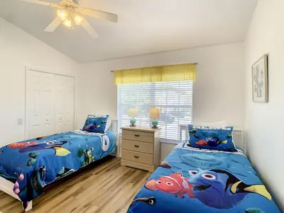 a bedroom with two beds and a window at Celtic Palms: Private Pool & Near Disney Magic in Kissimmee