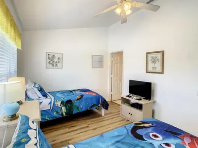 a bedroom with a bed and a tv in it at Celtic Palms: Private Pool & Near Disney Magic in Kissimmee