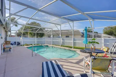 a patio with a pool with a glass roof at 6 Mi to Disney World Home with Large Yard! in Orlando