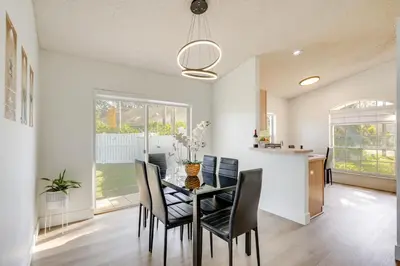 a dining room with a table and chairs at 6 Mi to Disney World Home with Large Yard! in Orlando
