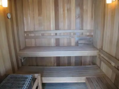 a small sauna with wooden walls and wooden shelves at Cane Island Resort 2BR Condo, Close to Attractions in Kissimmee