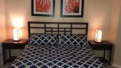 a bedroom with a bed with two lamps on two tables at Cane Island Resort 2BR Condo, Close to Attractions in Kissimmee