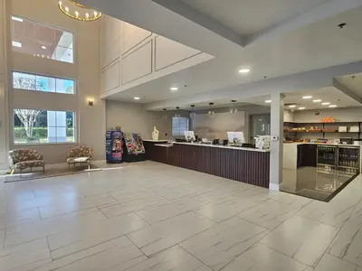 a large empty lobby with a bar in a building at Montreal Suites Orlando in Orlando