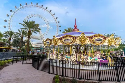 a carnival ride with a ferris wheel in the background at Montreal Suites Orlando in Orlando