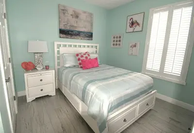 a bedroom with a bed with pink pillows on it at Best deal on Windsor Palms South facing pool in Kissimmee