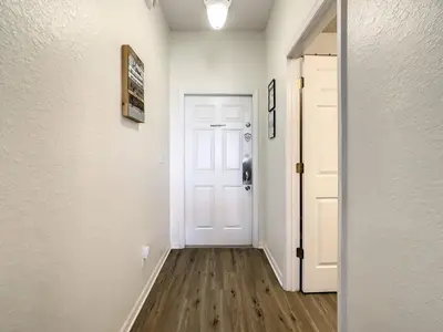 a hallway with a white door and a wooden floor at Old Town and Food trucks around the corner in Orlando