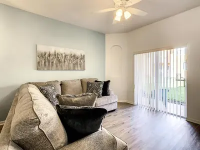 a living room with a couch and a ceiling fan at Old Town and Food trucks around the corner in Orlando