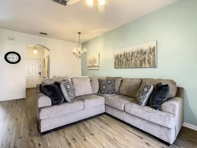 a living room with a large couch in a room at Old Town and Food trucks around the corner in Orlando
