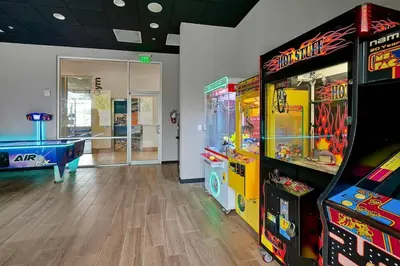 a room with two arcade games and a pool table at Old Town and Food trucks around the corner in Orlando