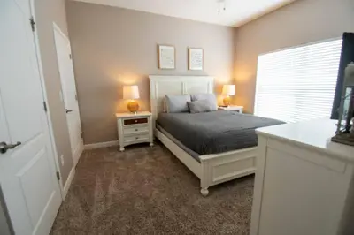 a bedroom with a bed with two night stands and a window at Great deal townhome on Paradise Palms in Kissimmee
