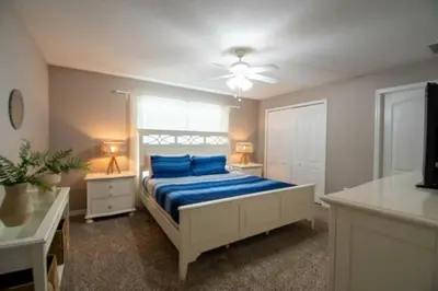 a bedroom with a bed with blue pillows on it at Great deal townhome on Paradise Palms in Kissimmee