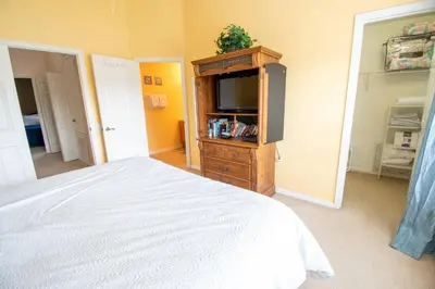 a bedroom with a bed and a flat screen tv at Great place to stay close to Disney Parks in Kissimmee