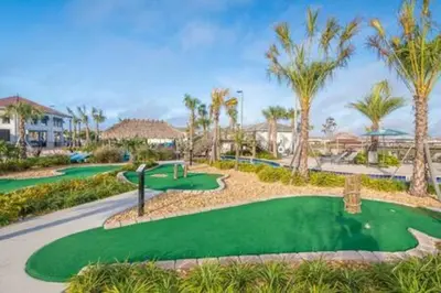 a golf course at a resort with palm trees at Serene Rhyme Escape in Kissimmee