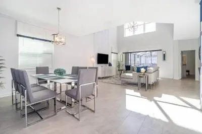 a dining room and living room with a table and chairs at Serene Rhyme Escape in Kissimmee