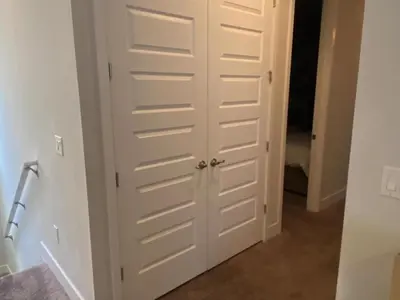 a closet with white doors in a hallway at Elegant Family Home | Pool, Spa & Themed Rooms in Orlando